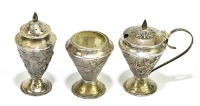 Lot 1360 - A Thai white metal three piece cruet with cast...