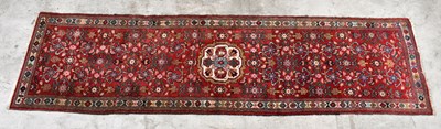 Lot 1446 - A Caucasian hand knotted wool runner, worked...