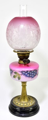 Lot 1192 - A Victorian oil lamp, the globular cranberry...