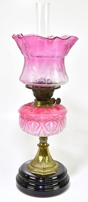 Lot 1193 - A Victorian glass oil lamp, the cranberry and...