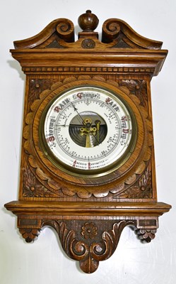 Lot 2252 - A late Victorian carved oak aneroid barometer,...