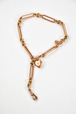 Lot 2191 - A 9ct rose gold trombone link Albert chain,...