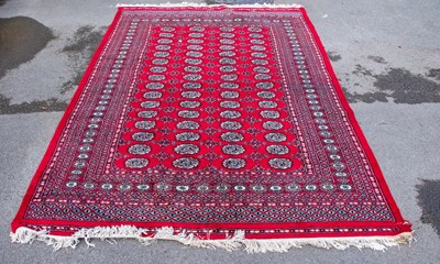 Lot 2323 - A hand knotted red ground Bokhara carpet, 293...