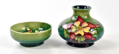 Lot 1563 - WALTER MOORCROFT; a squat vase in the...