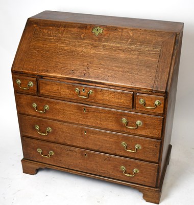 Lot 1507 - A George III oak bureau, with fall front...