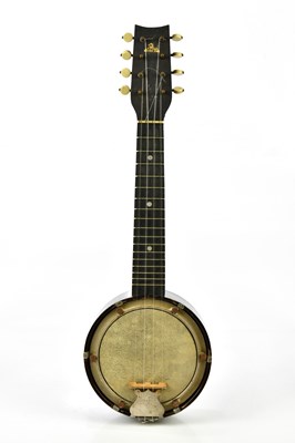 Lot 1325 - An early 20th century banjolele, cased.