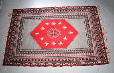 Lot 127 - An early 20th century hand knotted red ground...