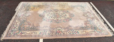 Lot 136 - A modern Chinese floral and beige carpet,...