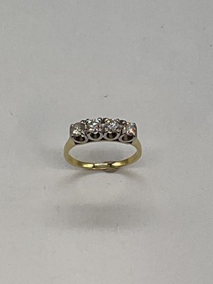Lot 379 - A 18ct yellow gold four stone diamond ring,...