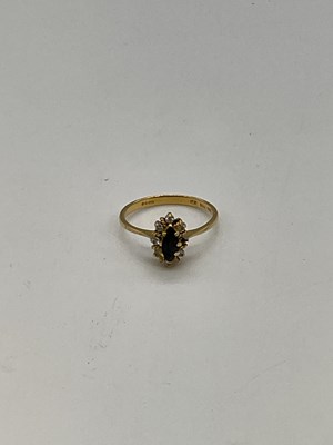 Lot 1273 - An 18ct yellow gold sapphire dress ring (one...