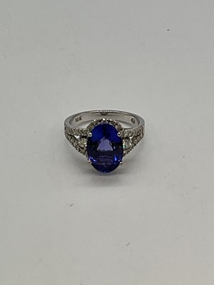Lot 1147 - An 18ct white gold tanzanite and diamond ring,...