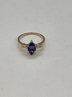 Lot 1180 - A 10ct yellow gold tanzanite and diamond ring,...