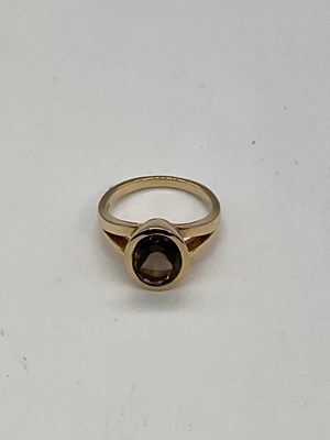 Lot 1195 - A 9ct yellow gold smoky quartz dress ring,...