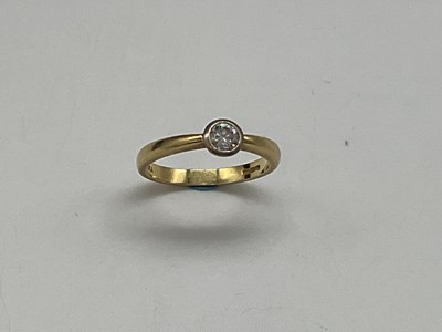 Lot 1182 - An 18ct yellow gold and diamond solitaire ring,...