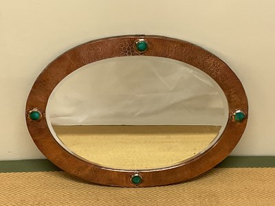 Lot 391 - An Arts and Crafts copper oval wall mirror...