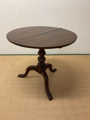 Lot 488 - An oak tilt-top table with turned central...