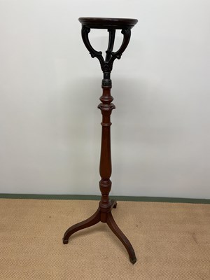Lot 522 - A mahogany torchere stand with brass collar...