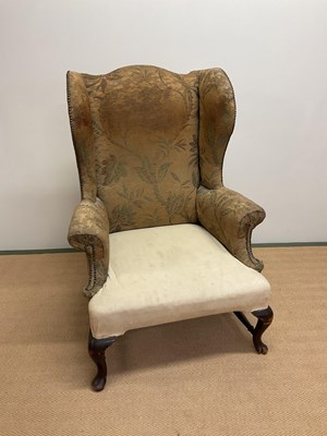 Lot 402 - A circa 1900 wingback armchair with stud...