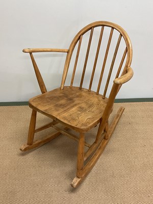 Lot 456 - ERCOL; a small stick back elbow rocking chair...