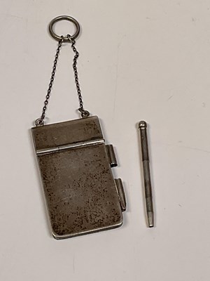 Lot 1132 - A chatelaine silver notebook and pencil on chain.