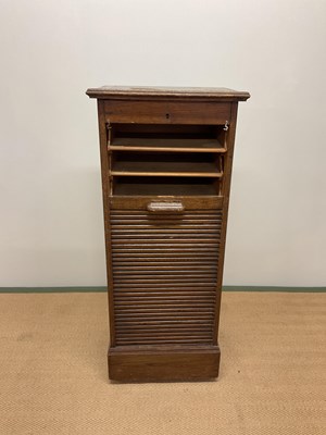 Lot 495 - Oak tambour filing cabinet with adjustable top....