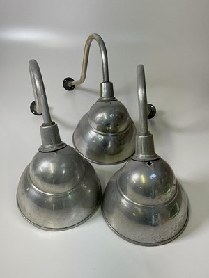 Lot 346 - Three industrial aluminium wall lights