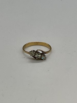 Lot 1219 - A yellow metal three stone diamond ring, the...