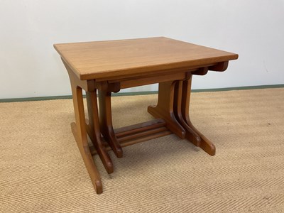 Lot 516 - A nest of three mid 20th century teak tables.