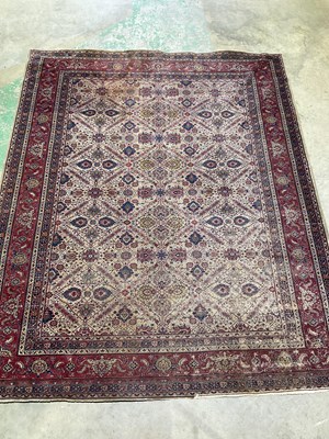 Lot 352 - A Persian designed rug with central motifs to...