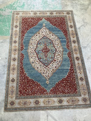 Lot 353 - A Persian designed rug with central shaped...