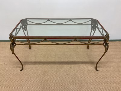 Lot 447 - IN THE MANNER OF MAISON JANSEN; a brass framed...