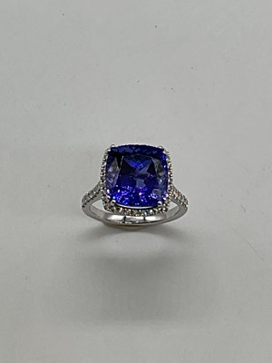 Lot 1144 - A platinum tanzanite and diamond ring, the...