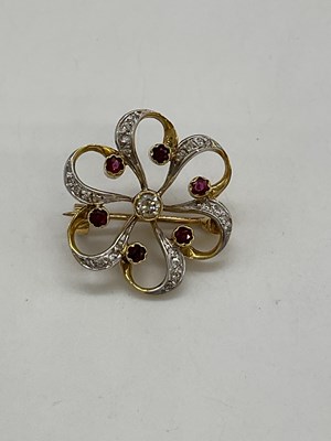 Lot 1203 - An 18ct yellow gold diamond and ruby pierced...
