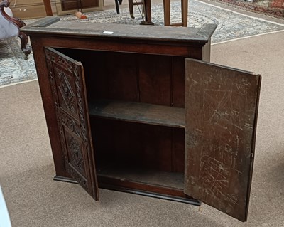 Lot 2352 - A 19th century carved oak cupboard with twin...
