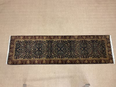 Lot 359 - A Persian inspired runner with central floral...