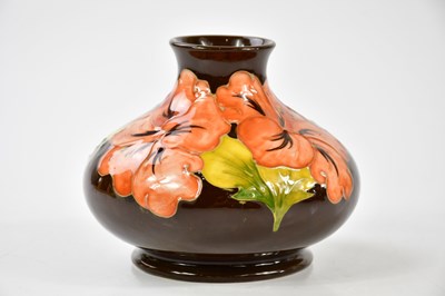 Lot 1554 - MOORCROFT; a 'Hibiscus' pattern squat vase,...