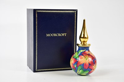 Lot 1543 - MOORCROFT; an enamel perfume bottle, with...
