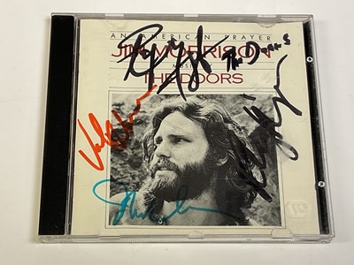 Lot 2109 - THE DOORS; a CD bearing signatures to the...