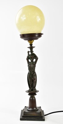 Lot 1202 - A bronzed metal figural lamp, the mottled...
