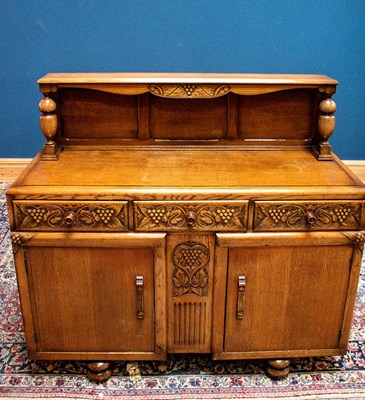 Lot 2587 - A 1940s oak sideboard with raised back, width...