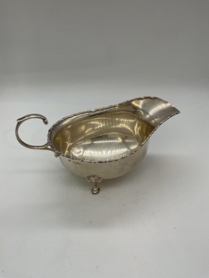 Lot 1086 - An Edwardian hallmarked silver sauce boat with...