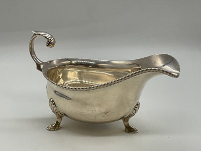 Lot 1049 - A George VI hallmarked silver sauce boat with...