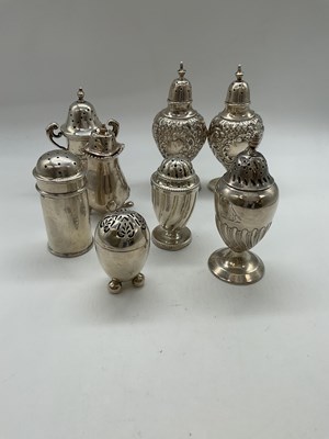 Lot 1043 - Eight variously hallmarked silver peppers...