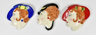 Lot 1511 - MOORLAND POTTERY; three ceramic face plaques,...