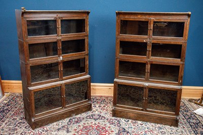 Lot 2363 - A pair of oak four tier bookcases with hinged...