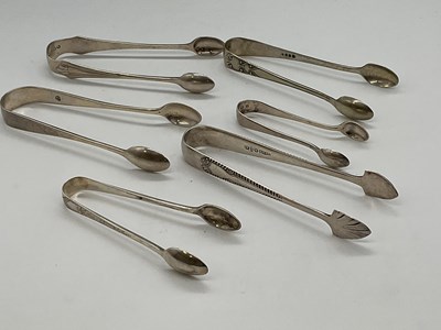 Lot 1045 - Five pairs of hallmarked silver sugar tongs...