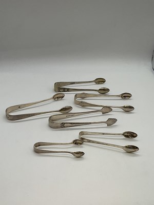 Lot 1045 - Five pairs of hallmarked silver sugar tongs...