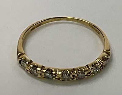 Lot 1243 - An 18ct yellow gold seven stone half eternity...