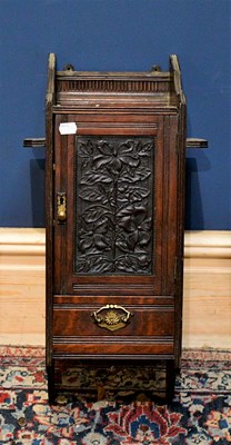Lot 1020 - An early 20th century carved oak smoker's...