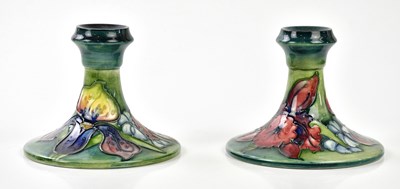 Lot 139 - WALTER MOORCROFT; a pair of squat candlesticks...
